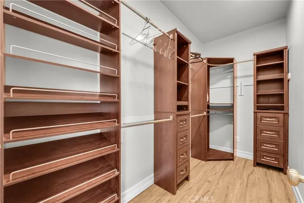a view of walk in closet with empty racks