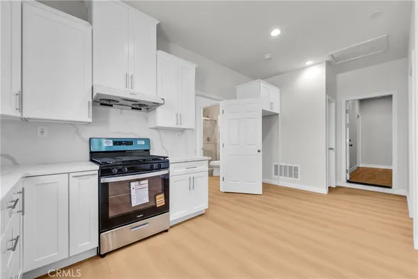 a kitchen with stainless steel appliances granite countertop a stove and a refrigerator