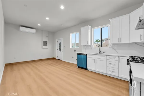 a kitchen with granite countertop a sink stainless steel appliances and cabinets