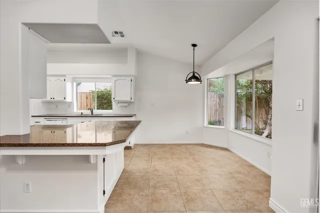 a view of a kitchen with a sink and windows