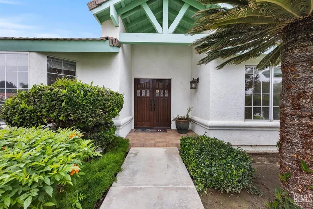a front view of a house with a garden