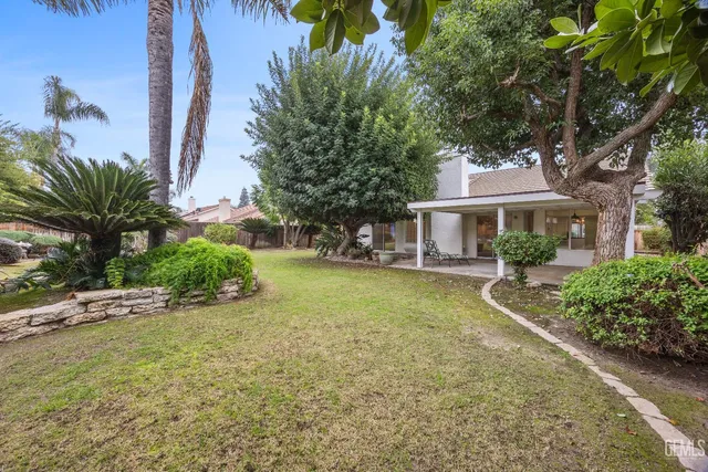 a front view of a house with a garden and yard