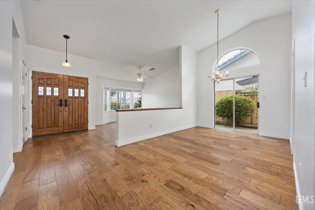 a view of an empty room with window and cabinet