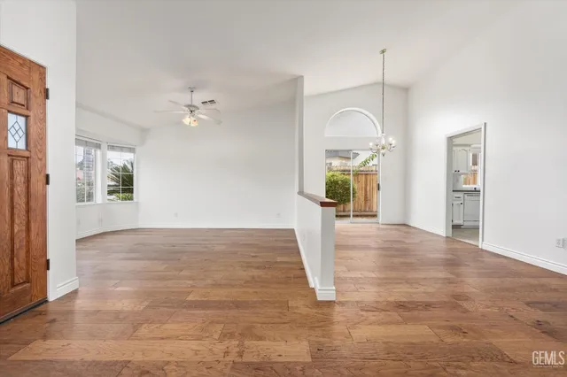 a view of a room with wooden floor and window