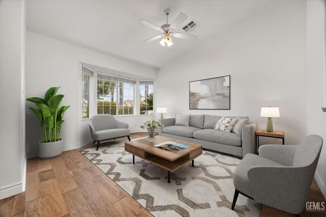 a living room with furniture a table and a potted plant