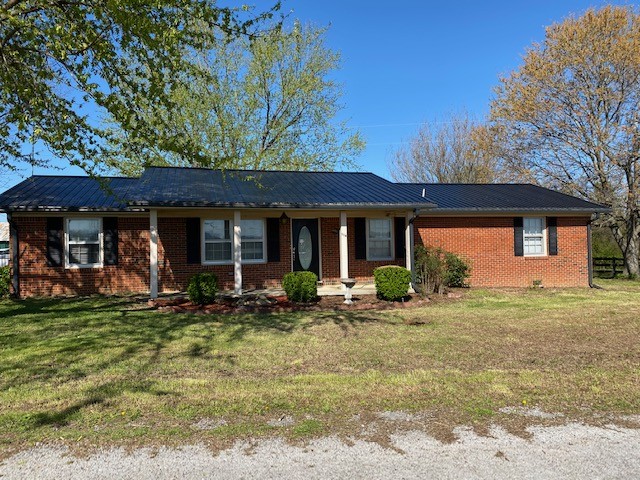 114 Pinegar Road Manchester, TN 37355 - Photo 1 of 1 a front view of a house with a garden and porch