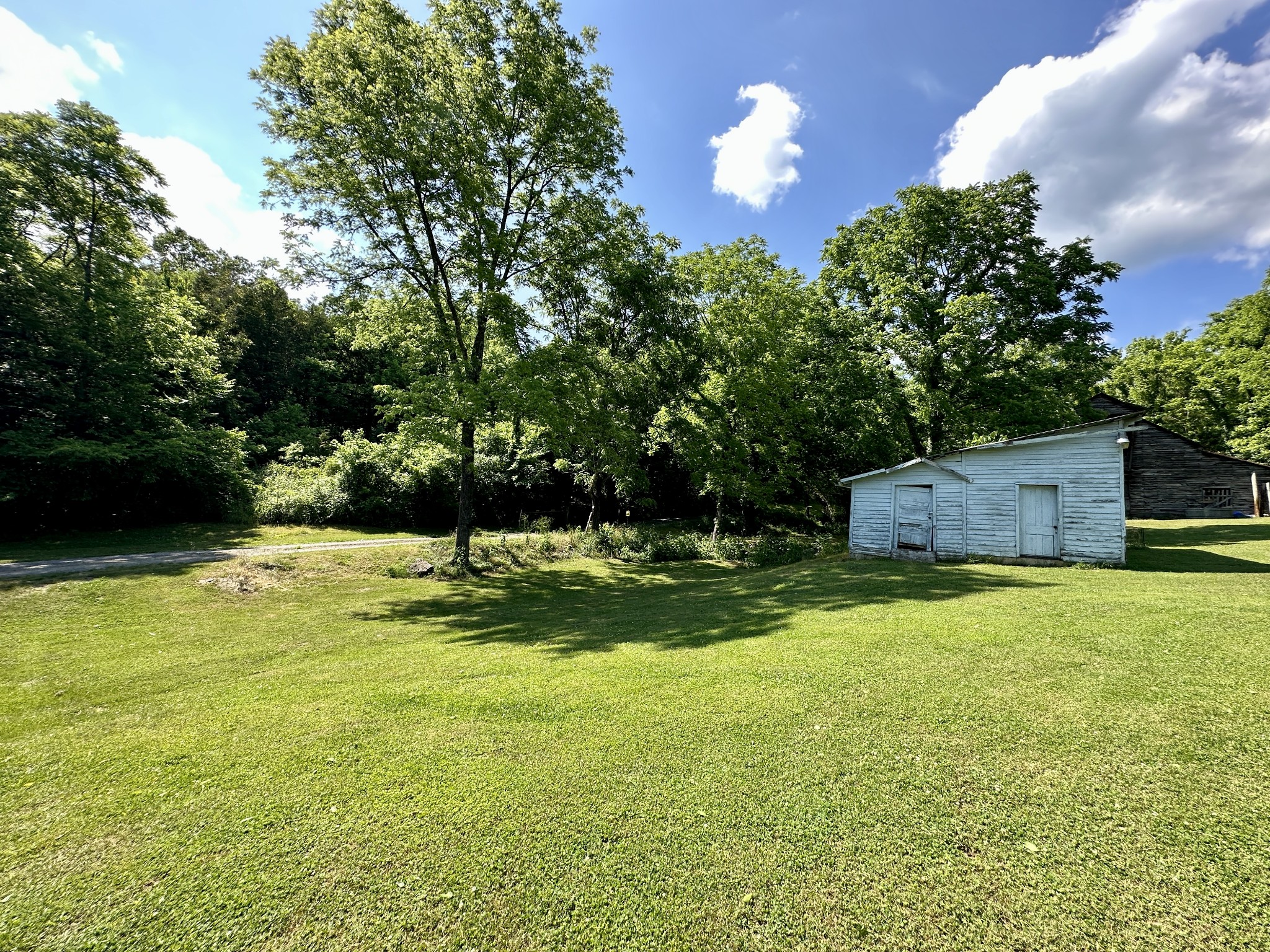 3437 Wolf Creek Road Silver Point, TN 38582 - Photo 39 of 70 a backyard of a house with a yard and outdoor seating
