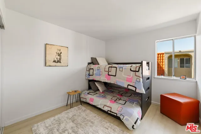 a bedroom with bed and a window