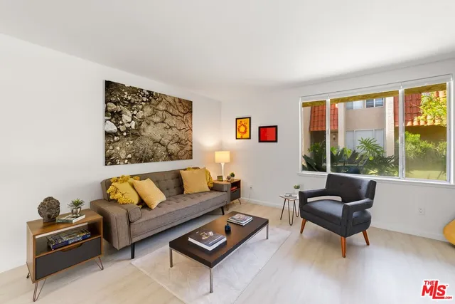 a living room with furniture and a large window