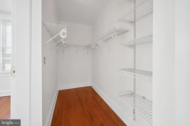 a bathroom with a toilet a sink a glass door a shower and a mirror