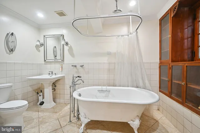 a front view of a house with a garden and sitting area