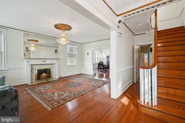 a view of a livingroom with furniture a fireplace and windows