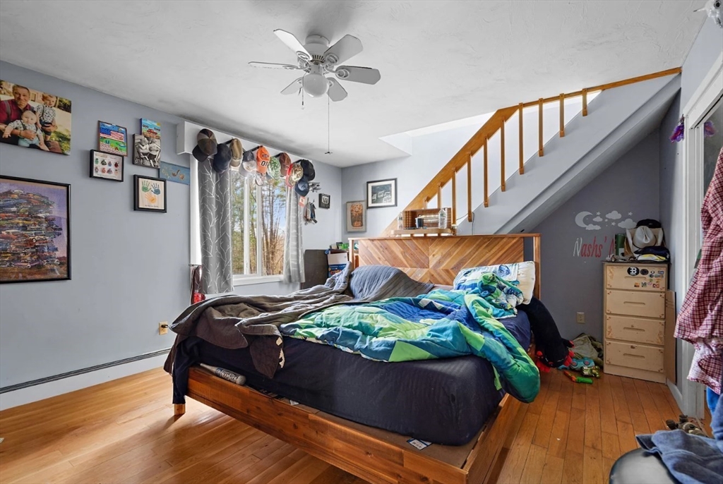 6 Plum Tree Lane Hubbardston, MA 01452 - Photo 17 of 31 a bed sitting in a bedroom next to a window