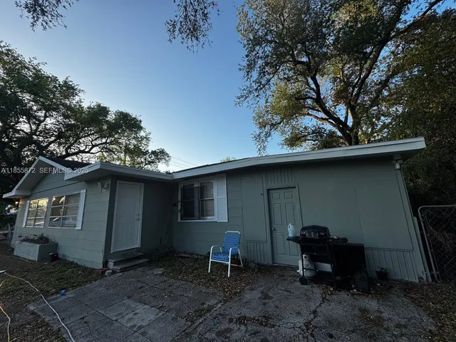 a backyard of a house with table and chairs