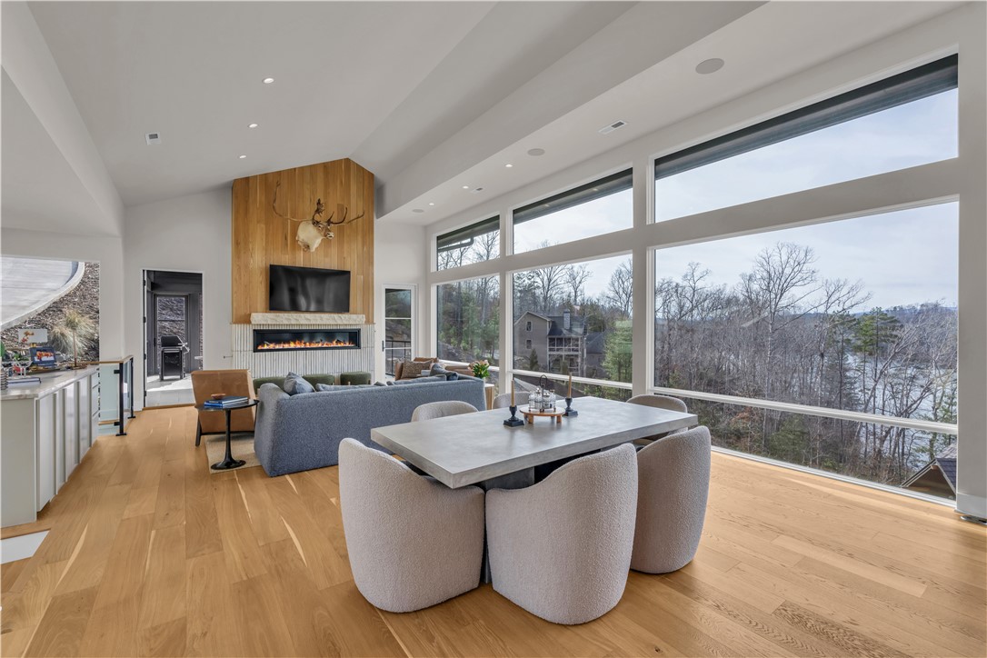 127 Crosswind Court Sunset, SC 29685 - Photo 21 of 49 This luminous space features expansive windows and a captivating fireplace, perfect for tranquil living.