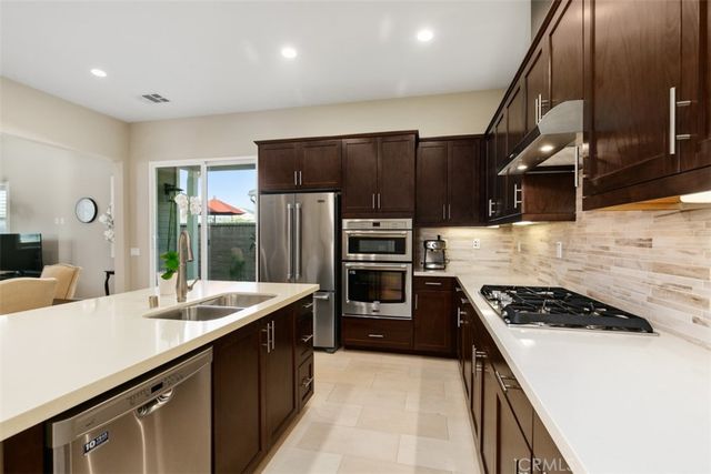 a kitchen with refrigerator and cabinets