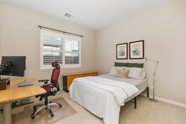 a bedroom with a bed and a desk