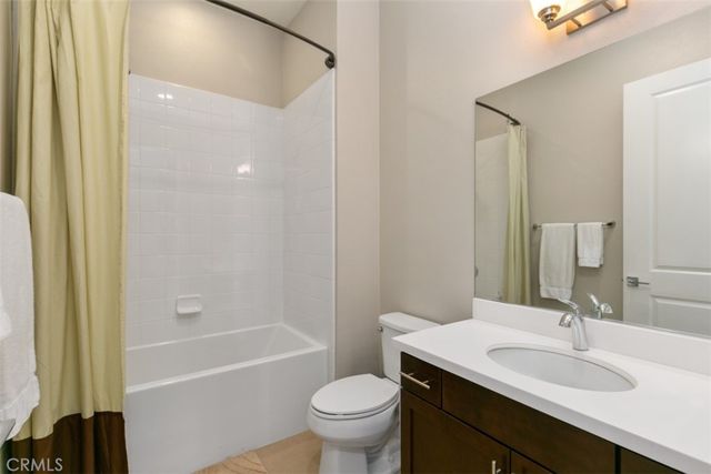 a bathroom with a sink a toilet and a large mirror