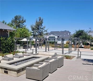a outdoor space with lots of white furniture and garden
