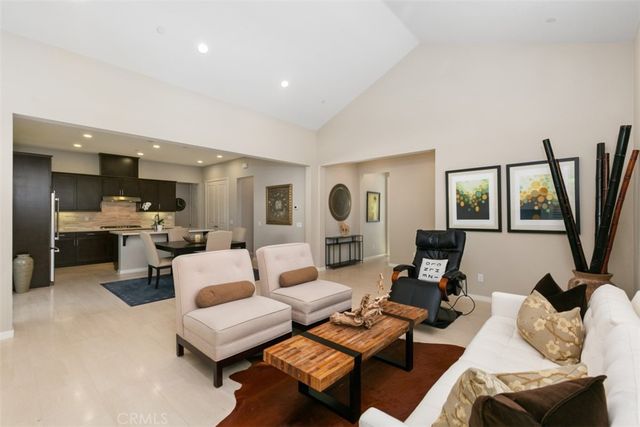 a living room with furniture window and a flat screen tv
