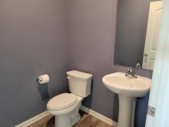 a bathroom with a sink a toilet and mirror