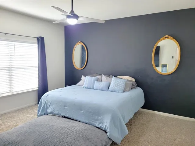 a bedroom with a bed and a window