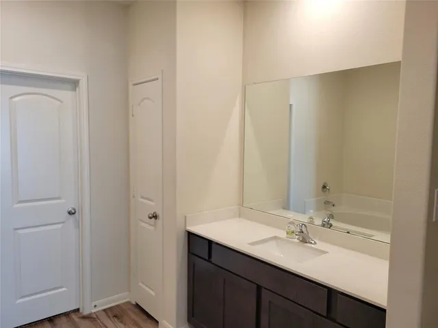 a bathroom with a shower curtain and a sink