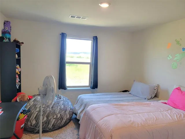 a bed room with a bed and a window