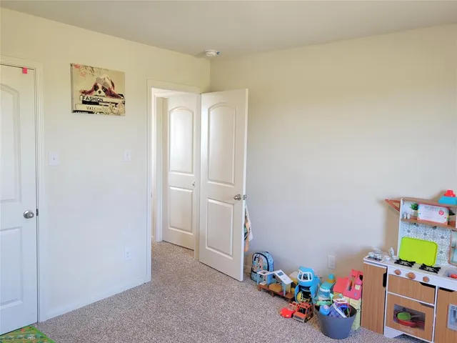 a view of a room with an empty space and wooden floor