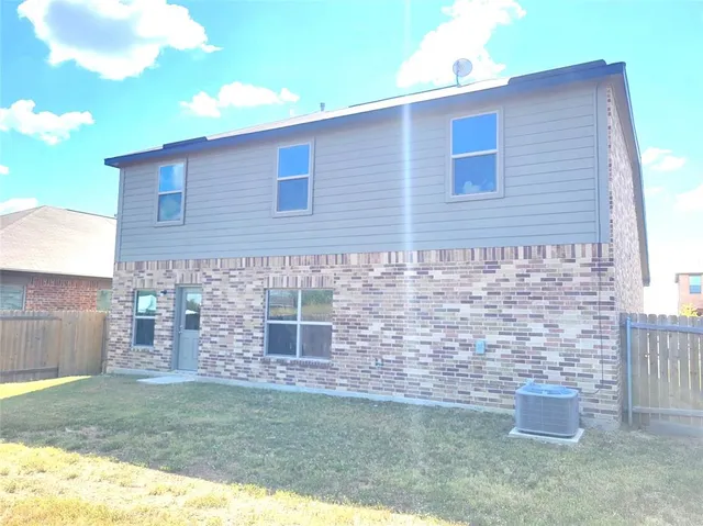 a brick house with a yard