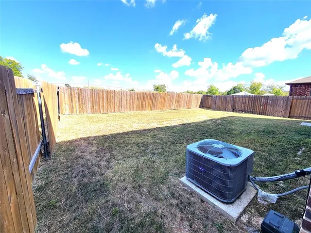 a view of a backyard with wooden fence