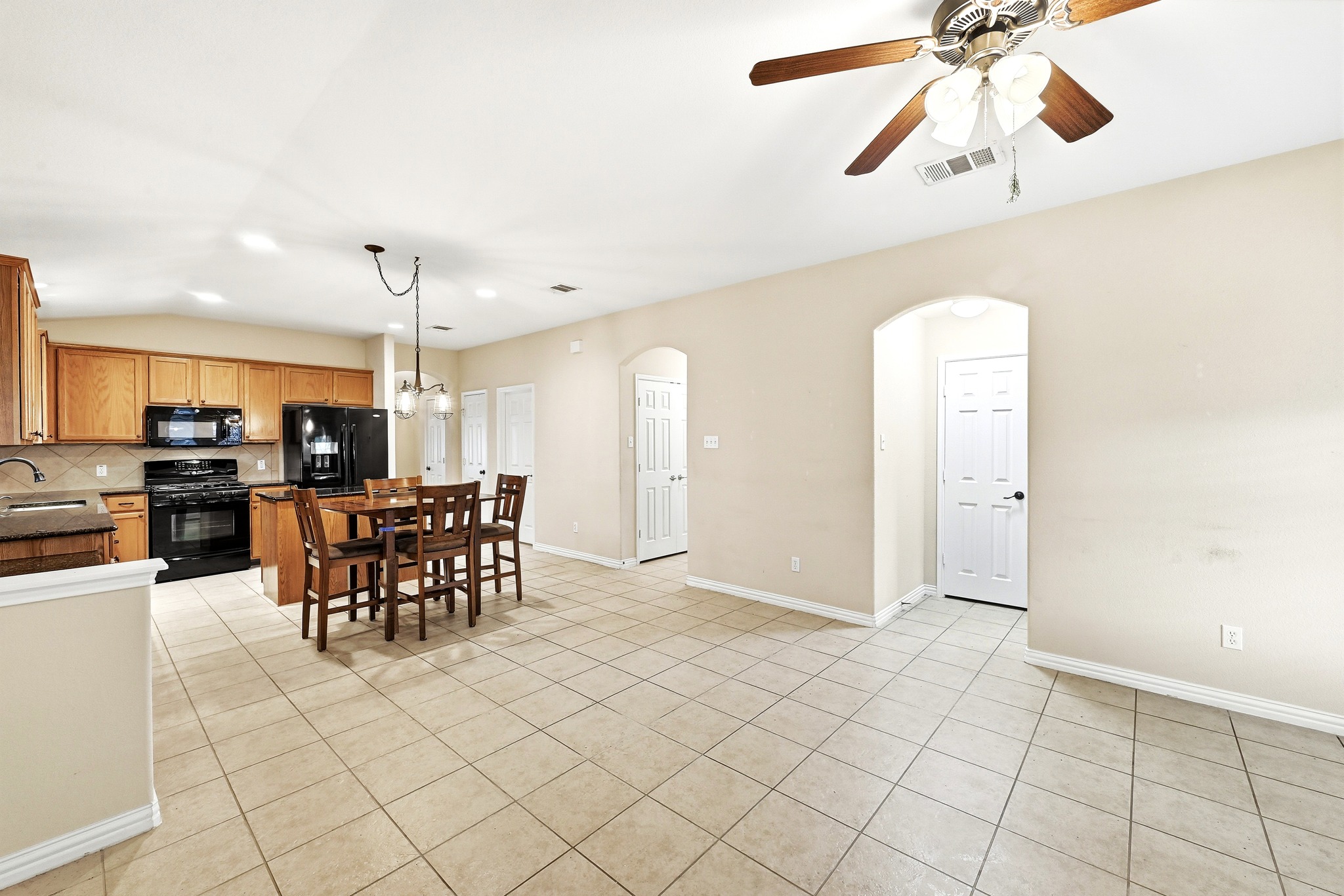 209 Calline Mayes Run Buda, TX 78610 - Photo 15 of 32 Kitchen and living space featuring ceramic tile flooring
