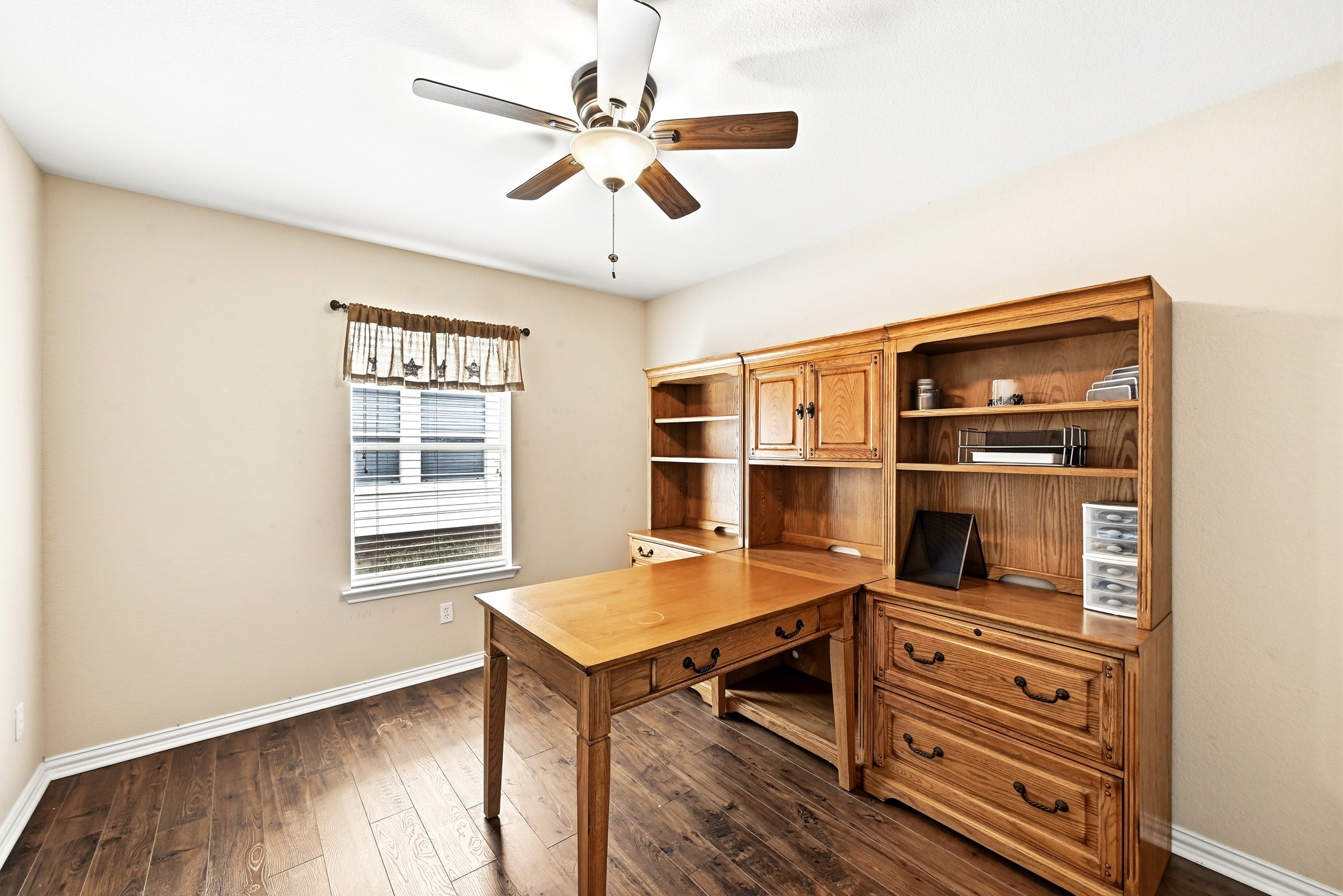 209 Calline Mayes Run Buda, TX 78610 - Photo 24 of 32 Bedroom featuring wood-finish flooring and a ceiling fan with integrated lighting