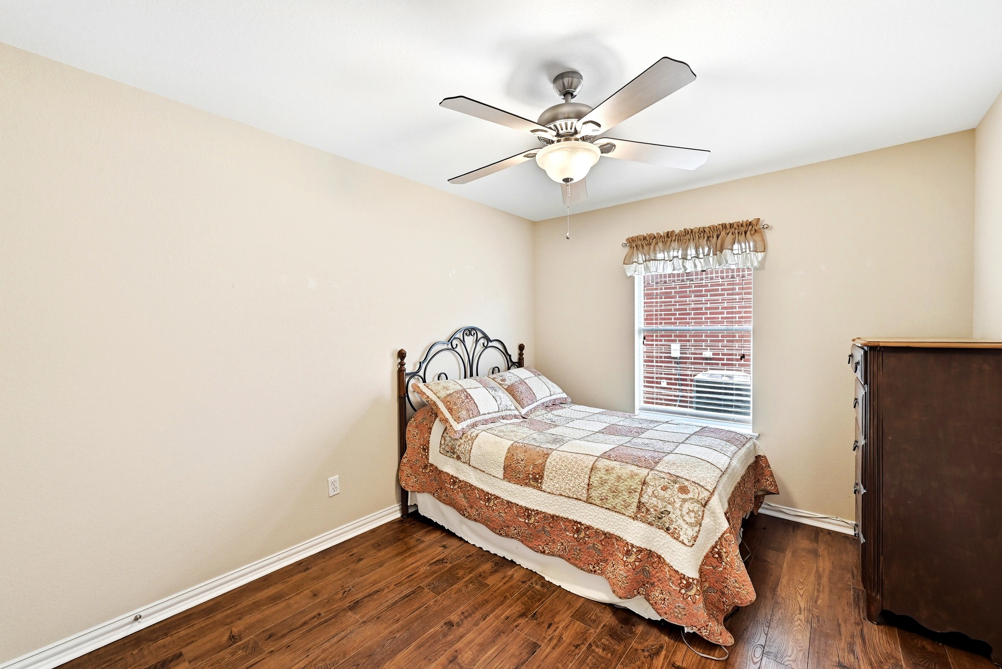 209 Calline Mayes Run Buda, TX 78610 - Photo 25 of 32 Guest bedroom featuring wood-finish flooring, a ceiling fan with integrated lighting, and a window with blinds