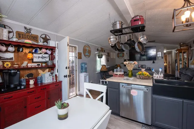 a kitchen with stainless steel appliances granite countertop a sink and cabinets