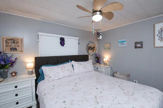 a bedroom with a bed and a chandelier