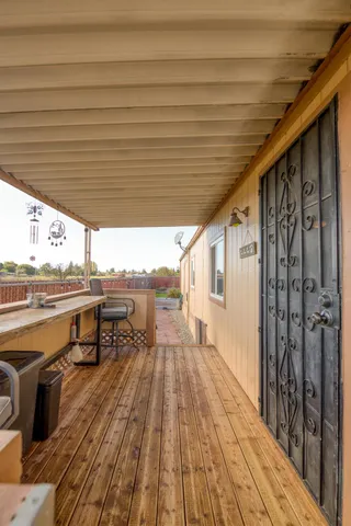 a view of a terrace with wooden floor and outdoor seating