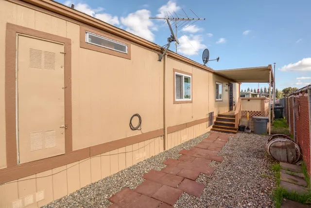 a view of a porch with a table and chairs