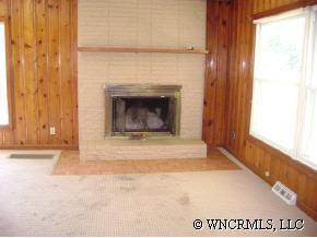 335 Osborne Ridge Road Canton, NC 28716 - Photo 3 of 9 a view of an empty room with a fireplace