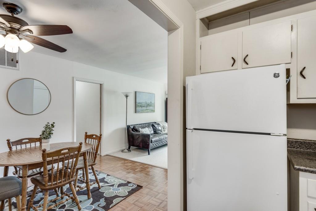 510 Coventry Road, Unit 19B Decatur, GA 30030 - Photo 21 of 31 a white kitchen with a refrigerator a table and chairs