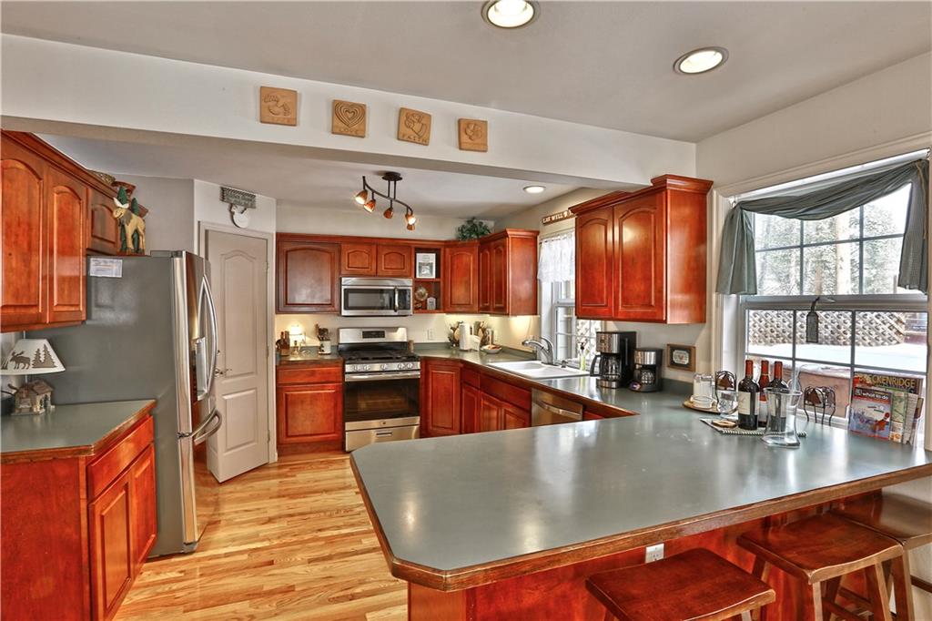 33 B Red Feather Road Breckenridge, CO 80424 - Photo 3 of 15 a large kitchen with stainless steel appliances granite countertop a sink a stove and a refrigerator