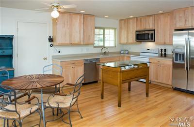 2690 Center Road Novato, CA 94947 - Photo 1 of 1 a kitchen with stainless steel appliances granite countertop a stove a sink a microwave a refrigerator and chairs