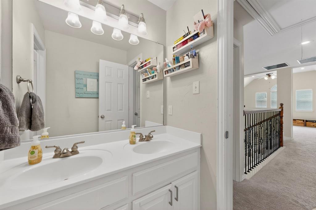 4004 White Porch Road Plano, TX 75024 - Photo 19 of 40 a bathroom with a sink and a mirror