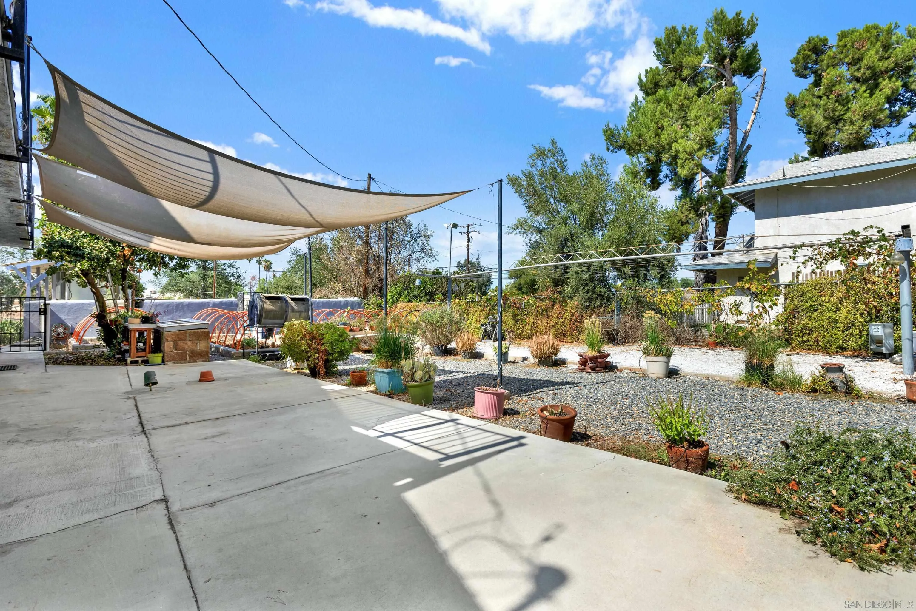 24220 Gunther Road Menifee, CA 92585 - Photo 54 of 68 a view of a patio with table and chairs potted plants