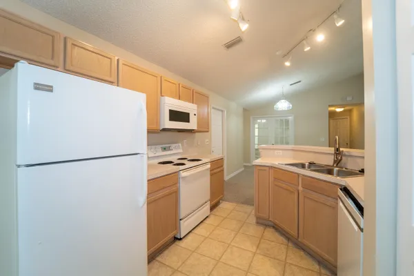 a kitchen with stainless steel appliances a refrigerator sink and stove