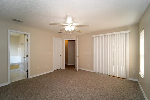 a view of a livingroom with a ceiling fan and window