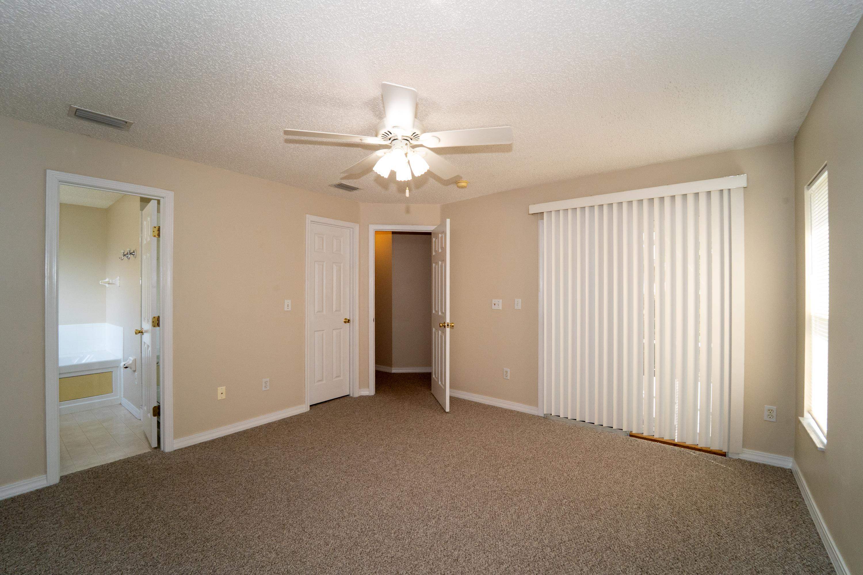 177 Marsh Island Circle St. Augustine, FL 32095 - Photo 15 of 33 a view of a livingroom with a ceiling fan and window