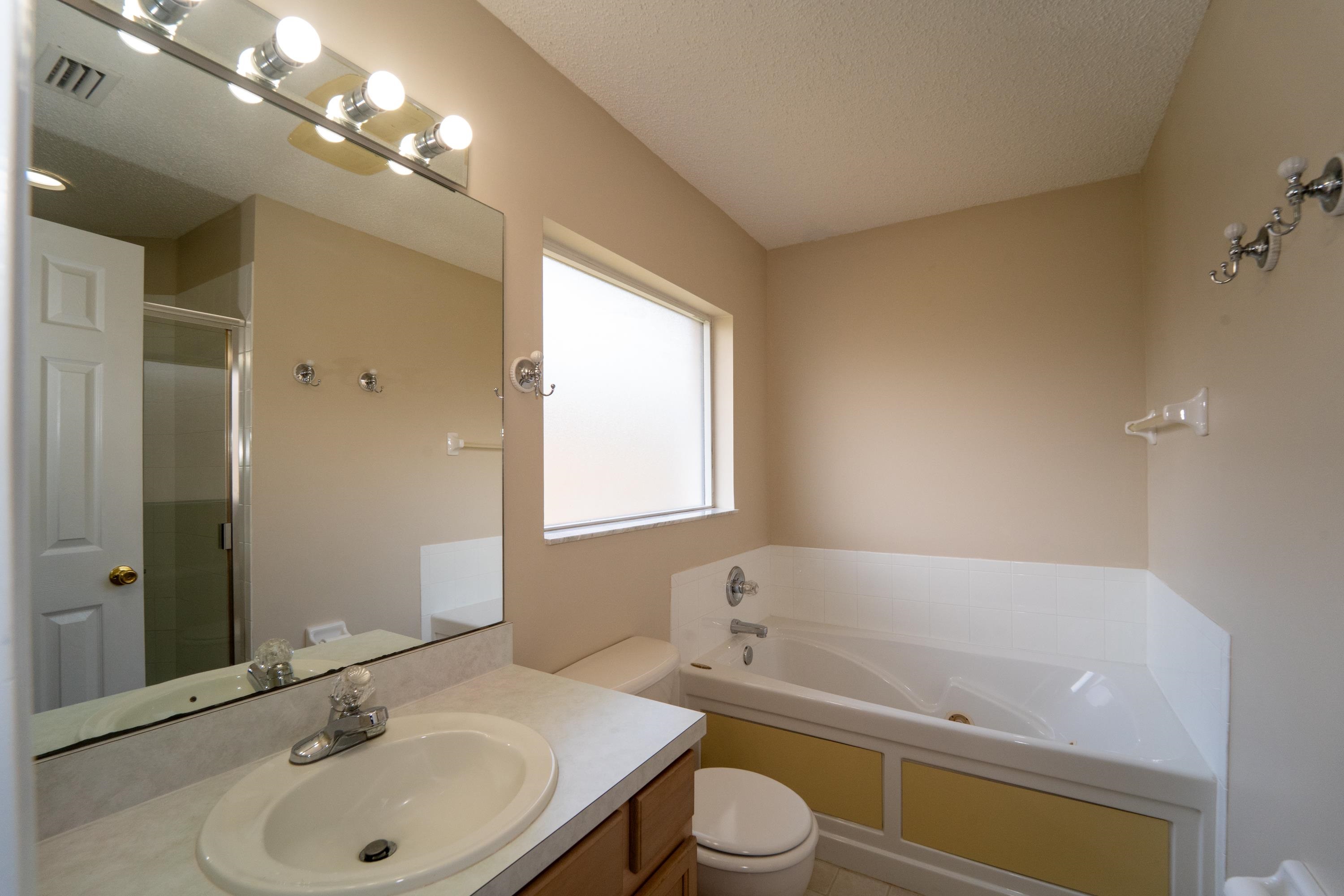 177 Marsh Island Circle St. Augustine, FL 32095 - Photo 18 of 33 a bathroom with a bathtub a sink a toilet and a mirror