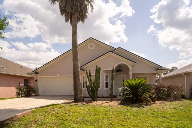 a front view of a house with a yard and garage