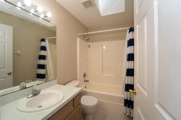 a bathroom with a glass shower door